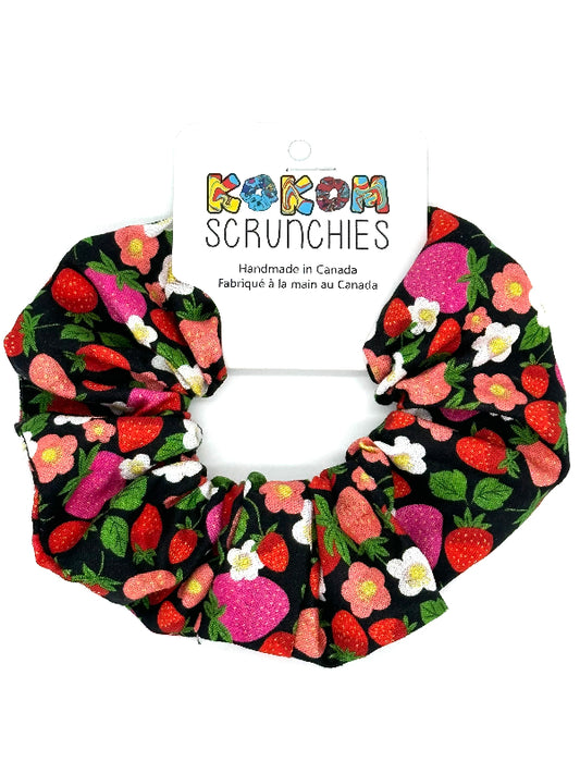 Scrunchie with strawberry pattern on a white background, featuring 'Kokom Scrunchies' branding.