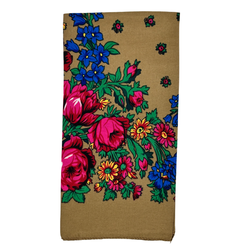 A light brown scarf with a floral pattern, including large pink flowers and green leaves.