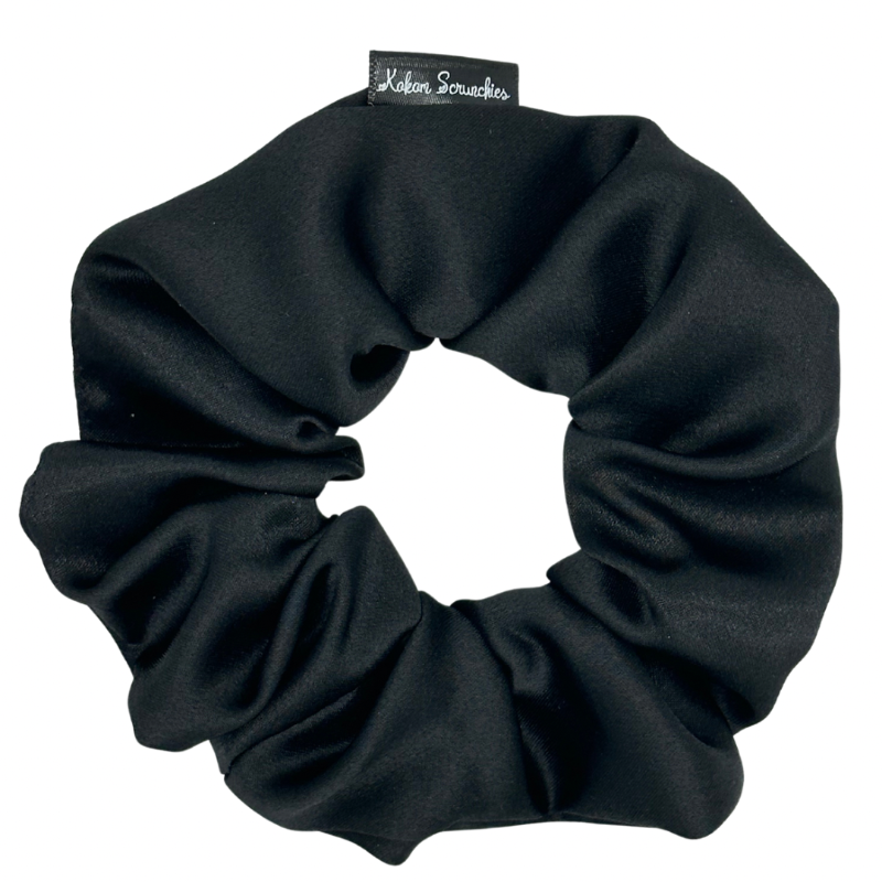 A black satin scrunchie with a visible brand tag.