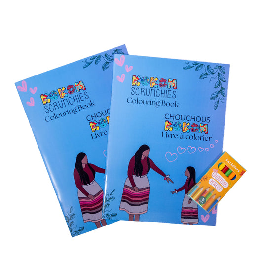 Two 'kokom scrunchies' colouring books with a set of crayons on a white background