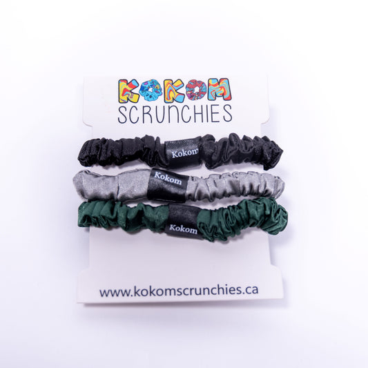 Set of Kokom scrunchies on a branded card with website information.