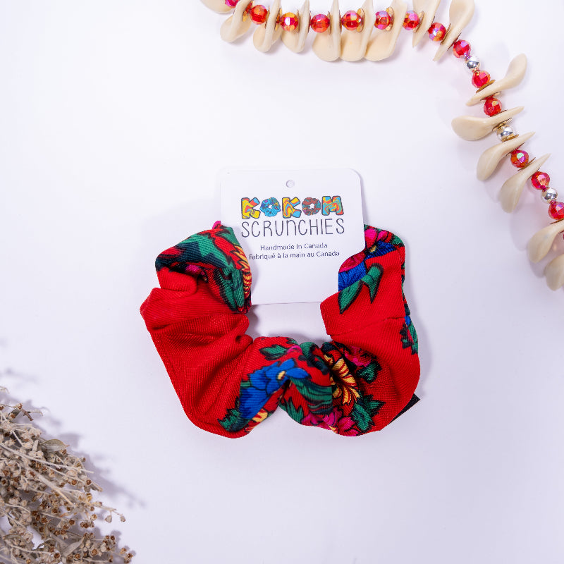 Red scrunchie with colorful patterns on a white background with 'kokom Scrunchies' packaging.