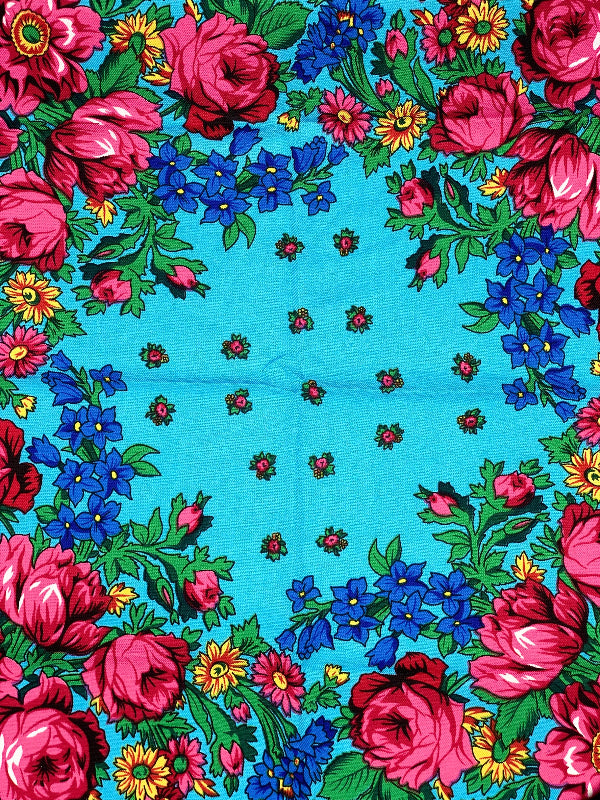 Floral patterned fabric with pink flowers on a light blue background