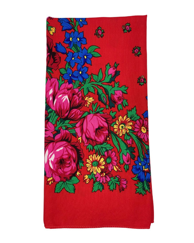 Red scarf with colorful floral pattern on a white background