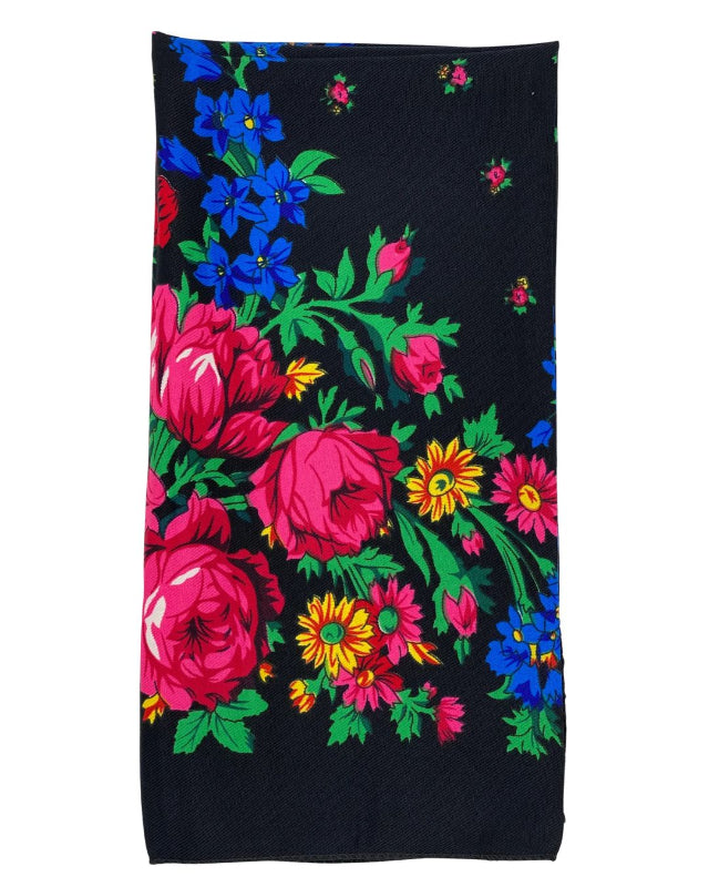 Black fabric with colorful floral embroidery on a white background