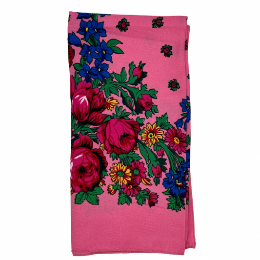 A light pink scarf with a colorful floral pattern.