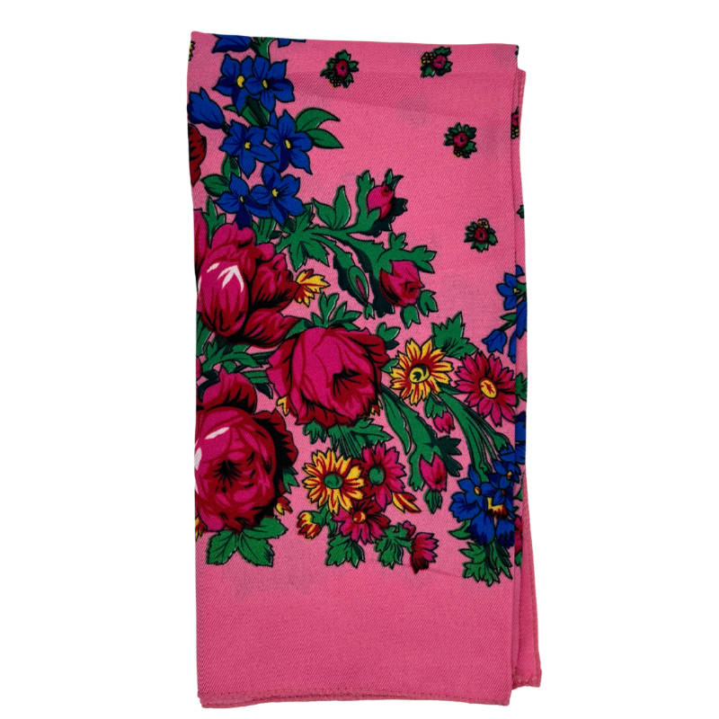 A light pink scarf with a colorful floral pattern.