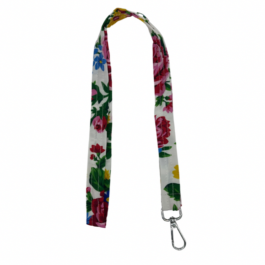 A white lanyard with a floral pattern, including red and green colors, and a metal clip.