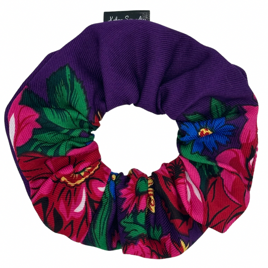 A hair scrunchie with a purple band and a floral pattern in multicolor.