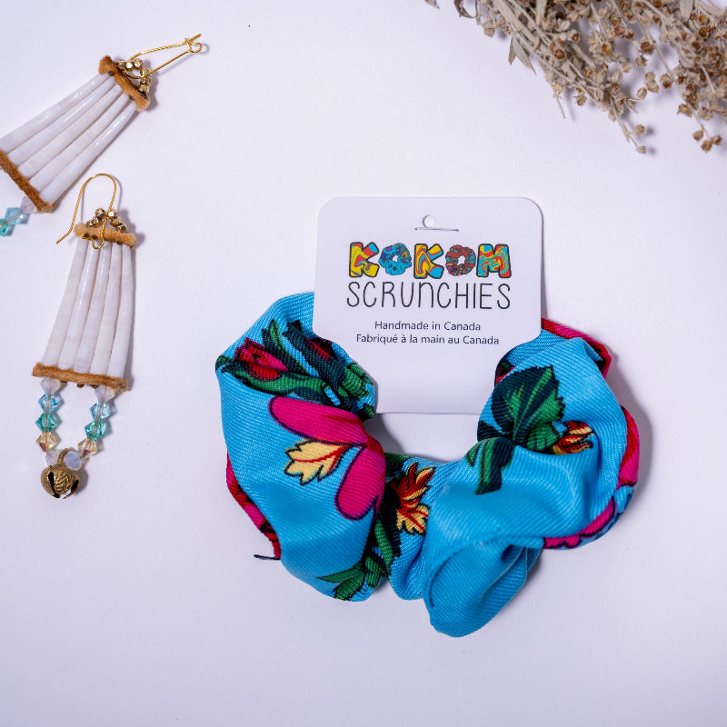 Colorful scrunchies with floral design on a white background, featuring a 'Kokom Scrunchies' card.
