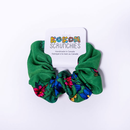 Green scrunchies with floral patterns on a white background, featuring a 'Kokom Scrunchies' card.