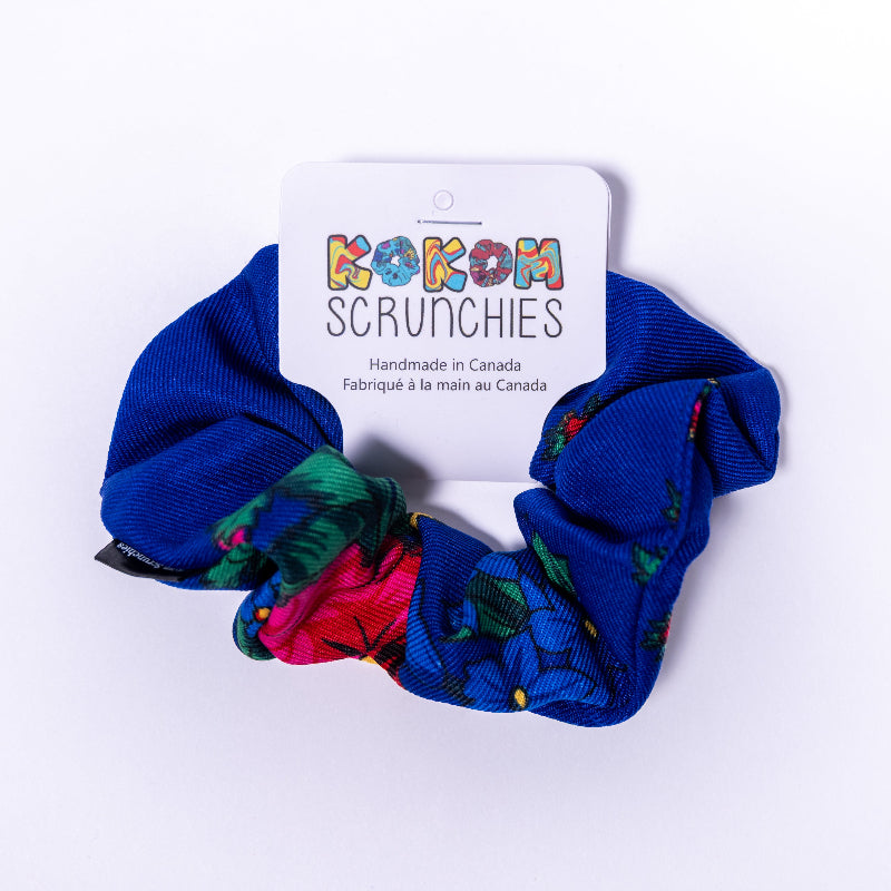  blue scrunchie with floral patterns on a white background, featuring a Kokom Scrunchies label.