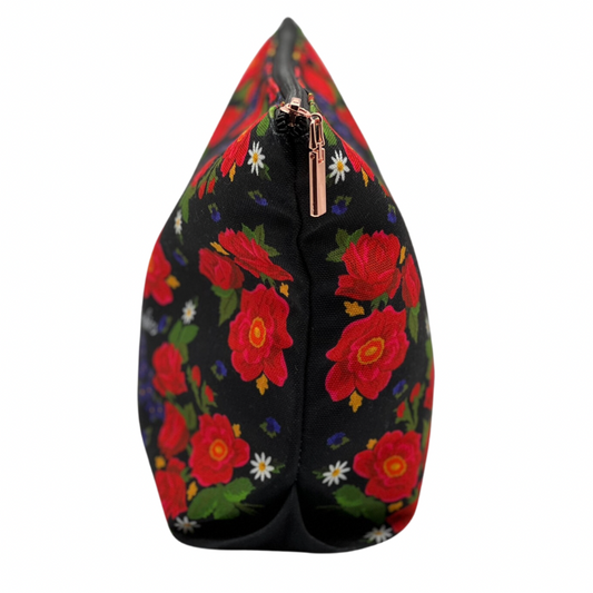 floral pattern with black background makeup bag turned sideways on a white background