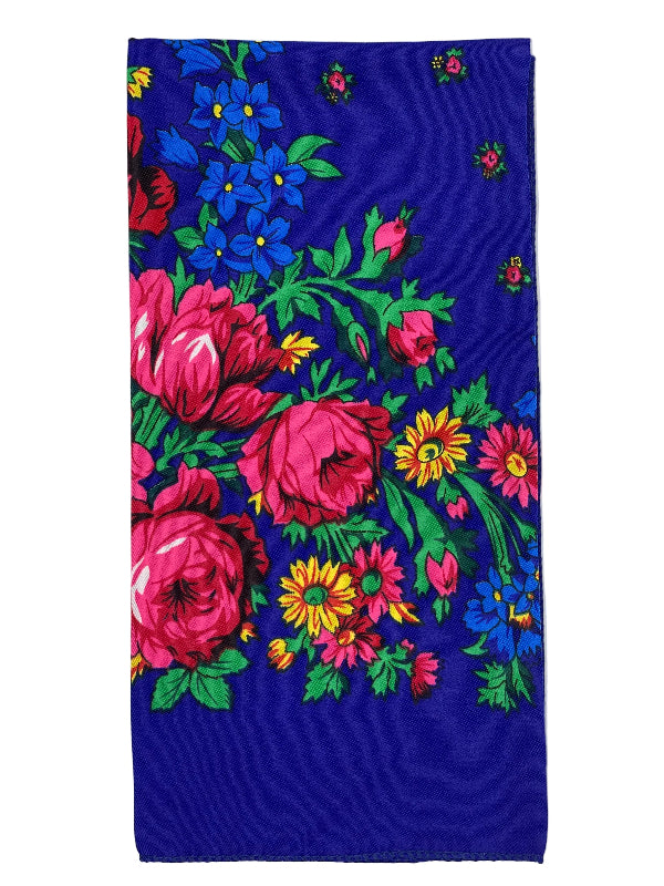 Floral patterned fabric with pink, yellow, and blue flowers on a blue background
