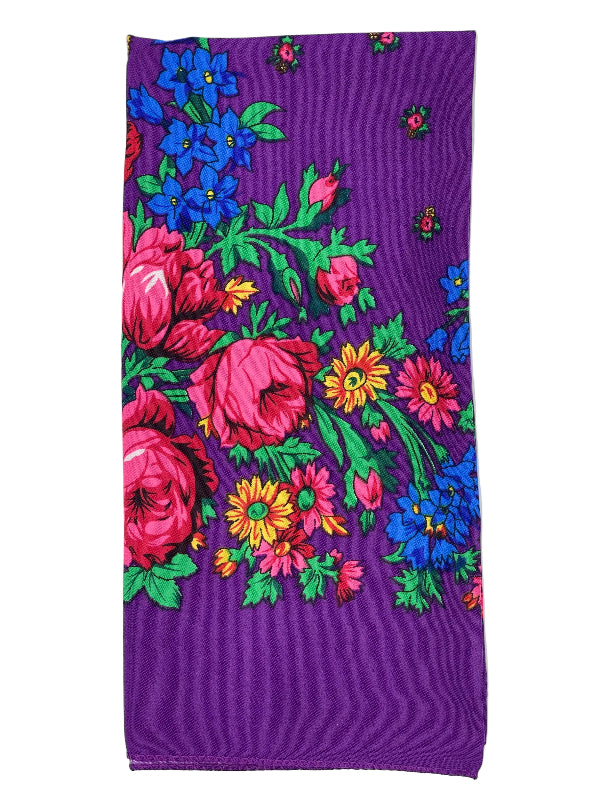Floral patterned fabric with vibrant colors on a purple background